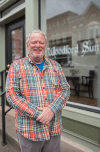 Scott White is the corps member working at the Woodford Sun. He had worked part time for the Sun for the past several years, but was never formally trained as a journalist. The pilot program is giving him the chance to grow into the full-time reporter he wants to become and that the Sun needs. (Photo by Kasey Ogle Photography)