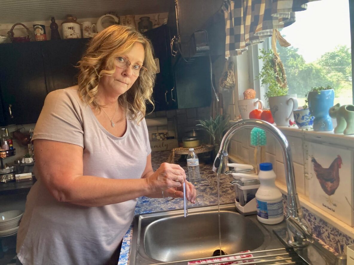 Cadiz resident Stacey Greer tests the pH and other aspects of her tap water. Photo by Julie Grant / The Allegheny Front