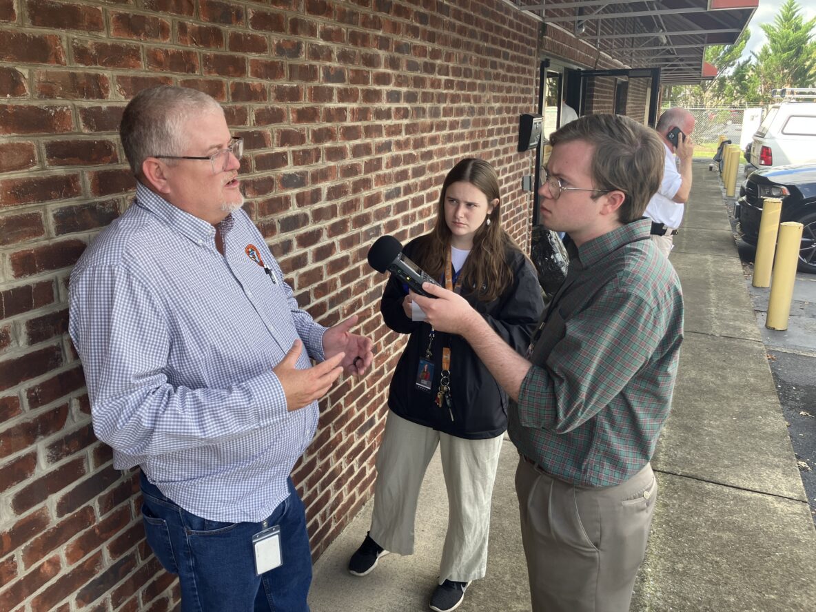 Pierce Gentry (right) of WUOT in Knoxville, Tenn., doing an interview out in the field. WUOT public radio is part of the Appalachia + Mid-South Newsroom collaboration